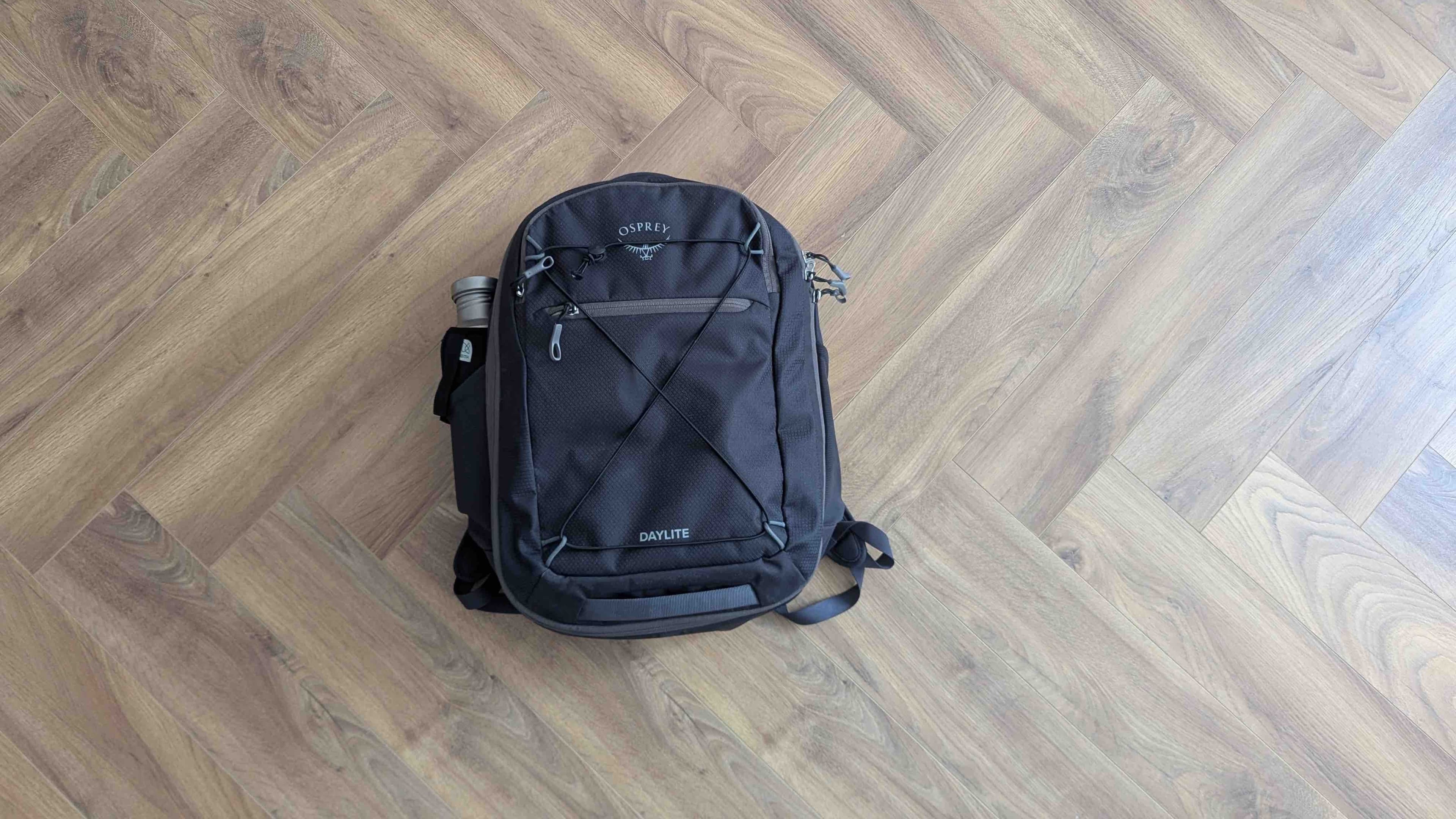 Top-down view of the Osprey Daylite 26+6L backpack closed, lying flat on the floor
